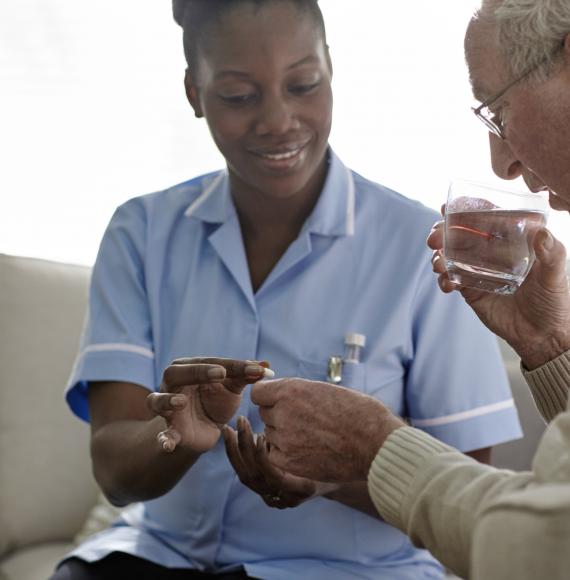 Female social worker helping an elderly resident