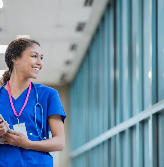 Nurse with a tablet walking in a hospital