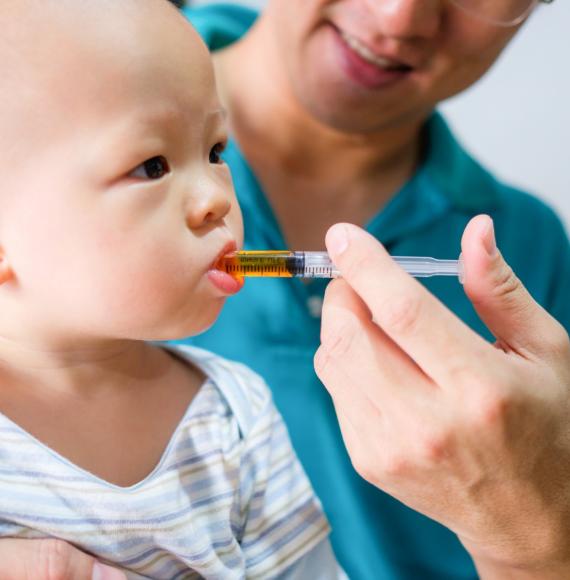 baby being given medicine 