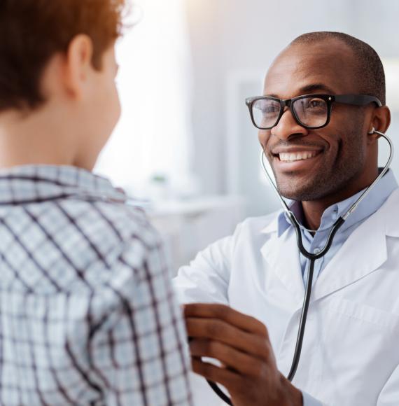 Doctor checking a child's airways with a stethoscope