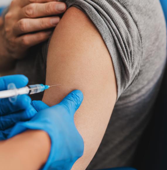 Vaccine being administered into a patient's arm