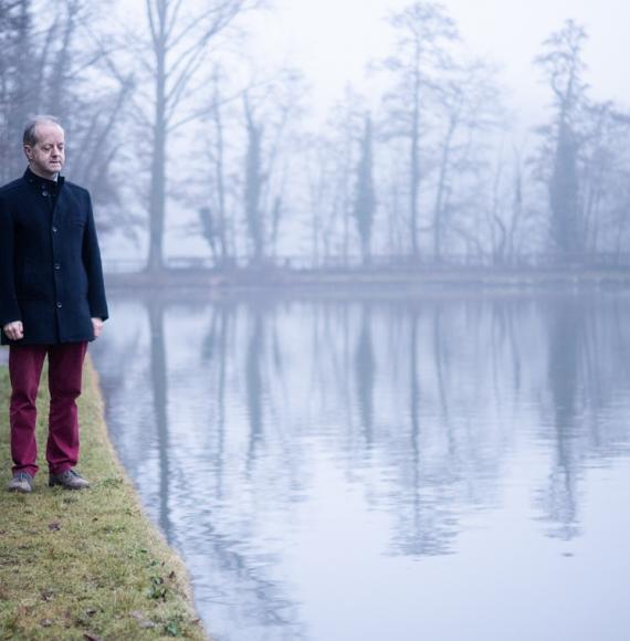 man standing near lake 