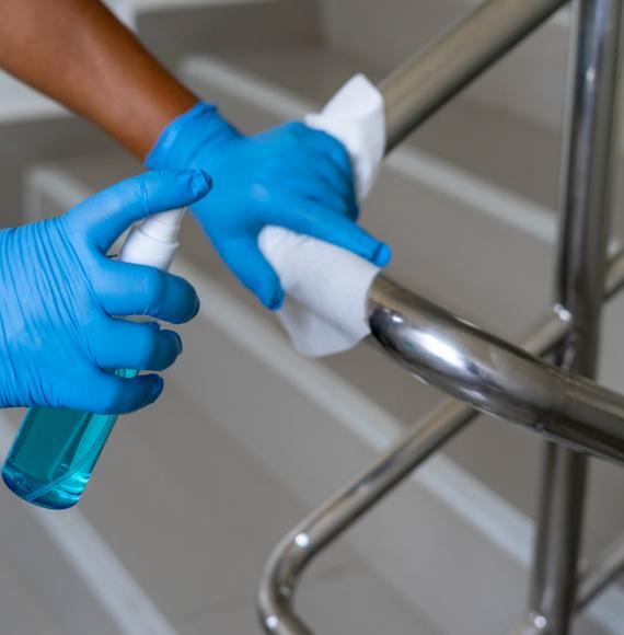 Cleaning a handrail with a microfibre cloth