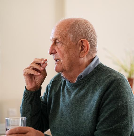 elderly man taking medication