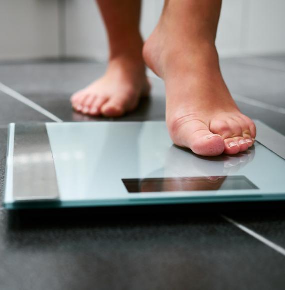person stepping on scale