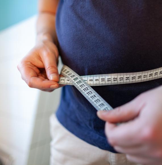 man measuring waist 