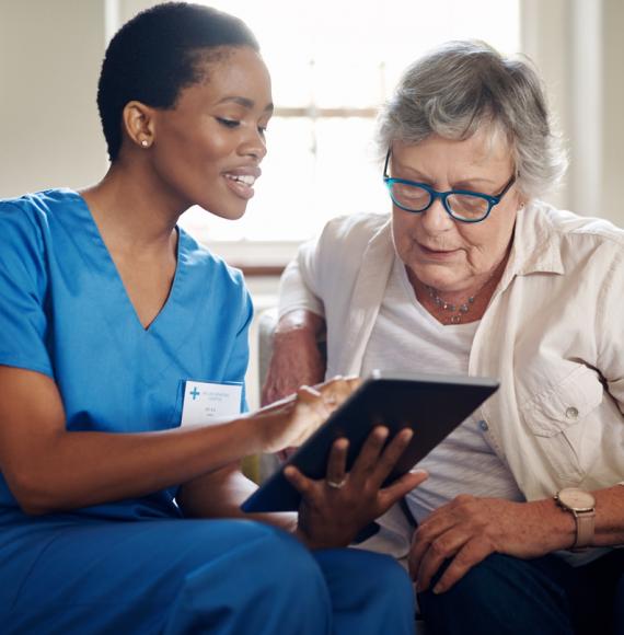 lady being helped to use ipad