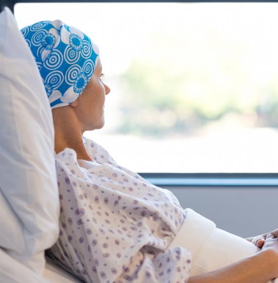 woman with cancer laying in hospital bed 