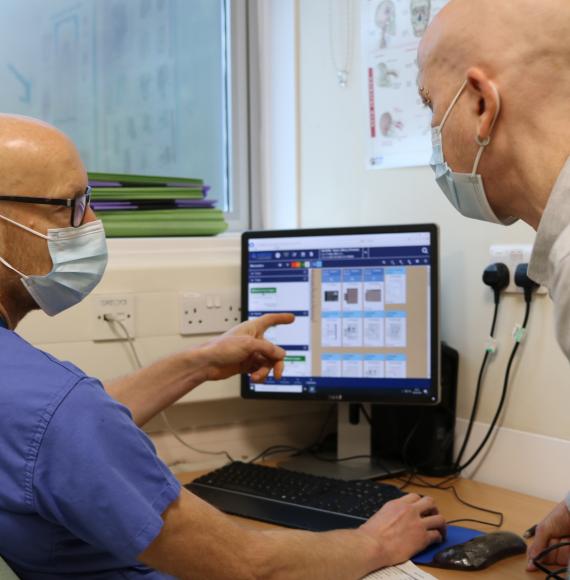 nhs staff looking at computer screen