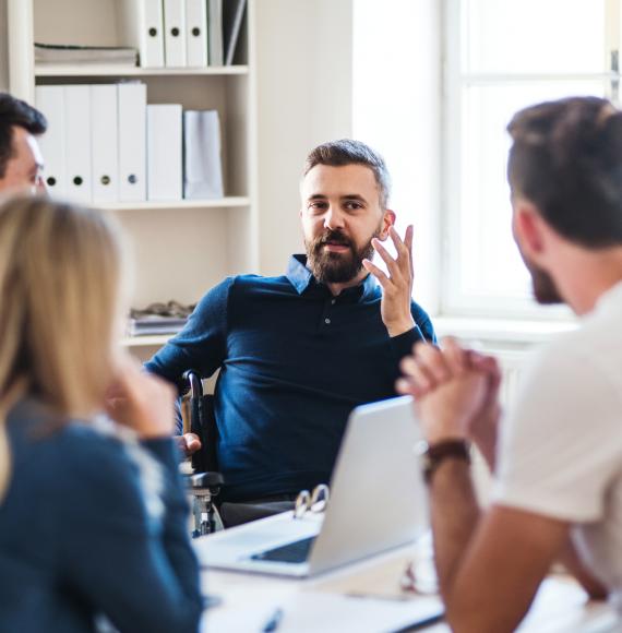 Man discussing in a meeting with colleagues