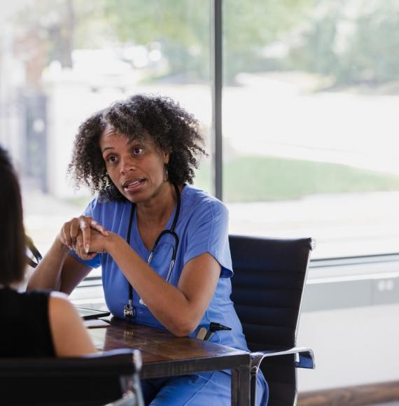 nurse talking to female patient