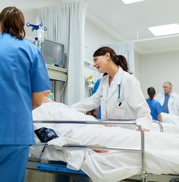 Doctor speaking to a patient in a hospital bed