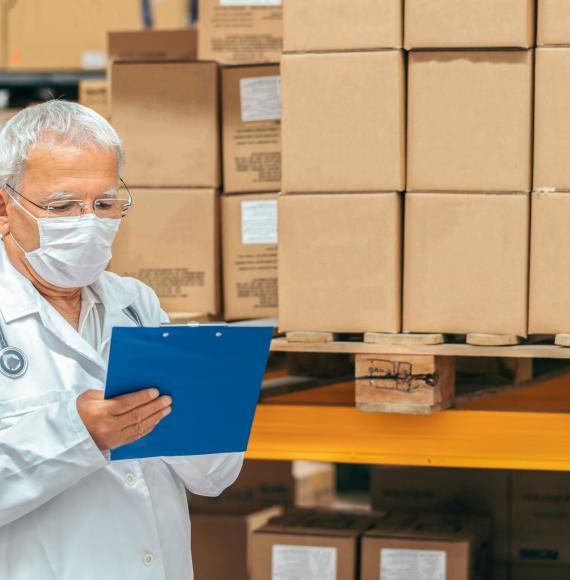 Health professional checking supplies in a warehouse