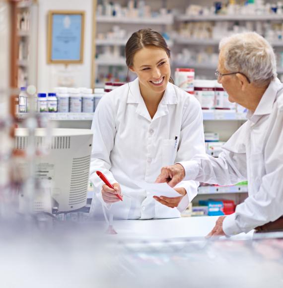 Pharmacist helping an elderly man