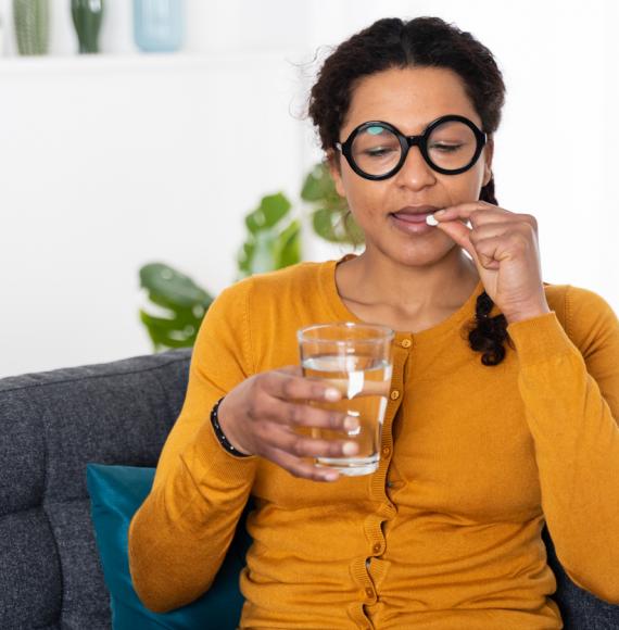 Woman taking tablet