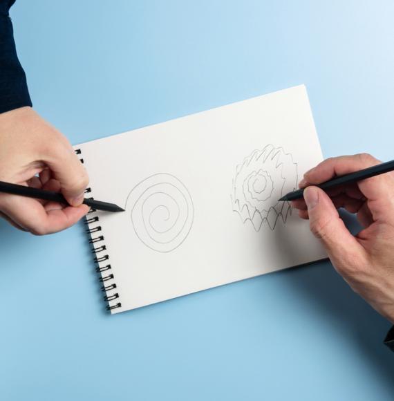 Two people drawing spirals