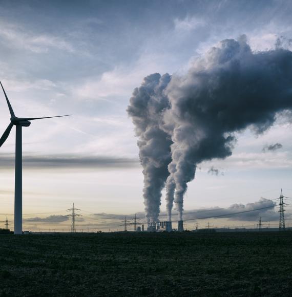 Wind turbine next to power plant