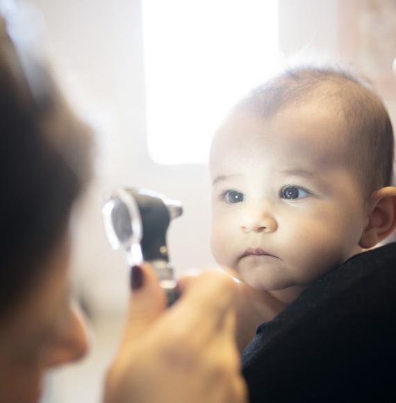 Doctor examining a baby's eye