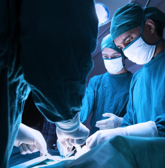 Surgeons operating on patient