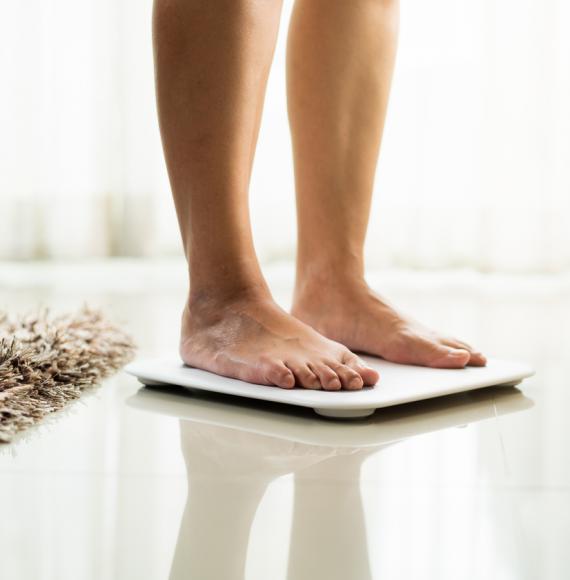 Woman standing on scales