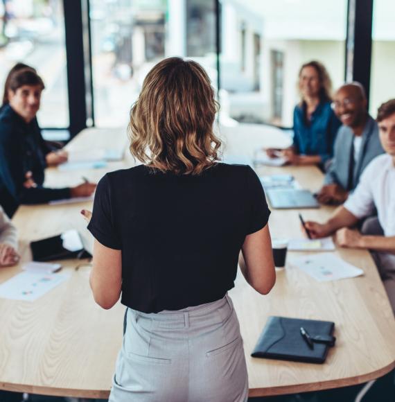 Woman addressing business meeting