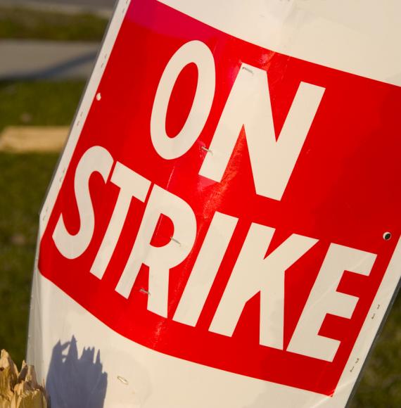 Red and white 'On Strike' sign