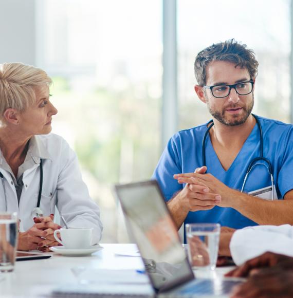 Healthcare workers talking in a meeting