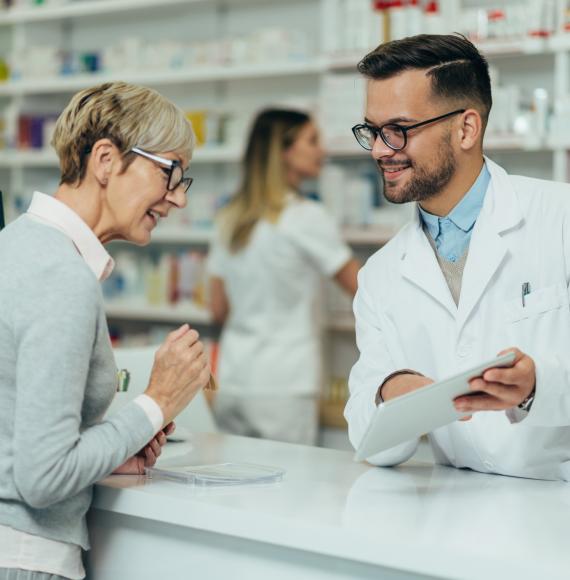 Pharmacist talking to woman