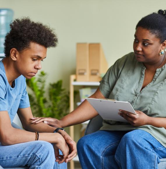 Psychologist with young boy in an office