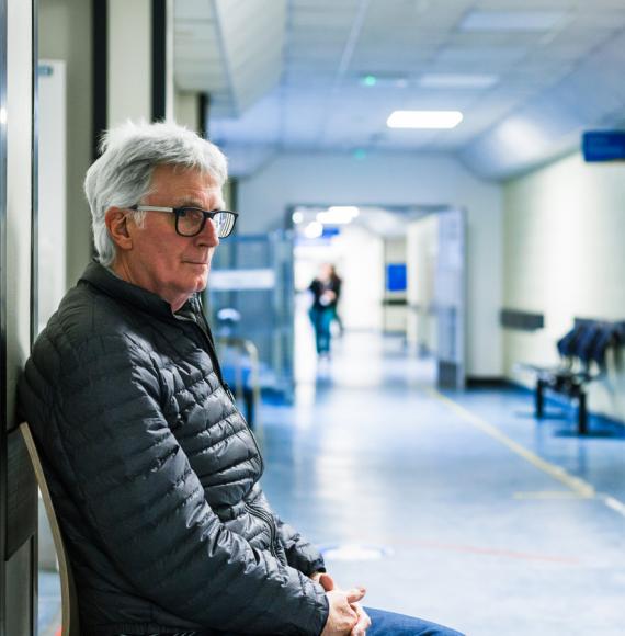 Man waiting in hospital corridor