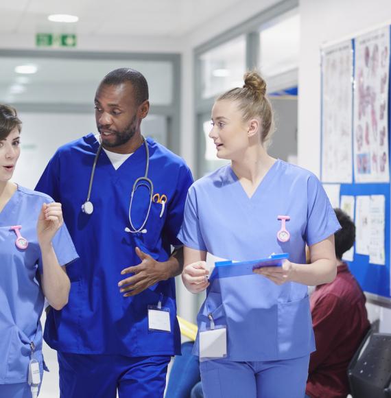 Health professionals walking through corridor and talking