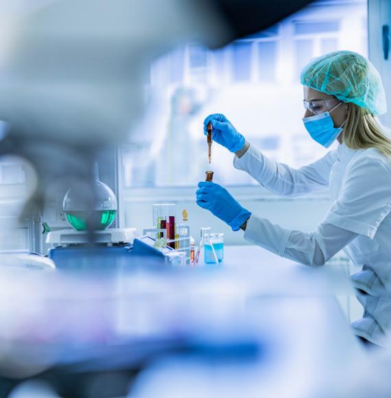Female scientist examining toxic liquid in laboratory