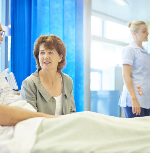 Elderly male patient in hospital bed