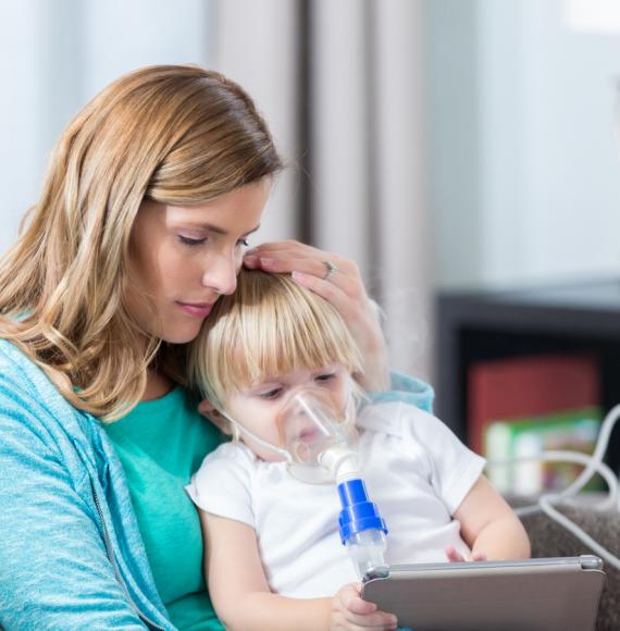 Young girl with cystic fibrosis receives breathing treatment