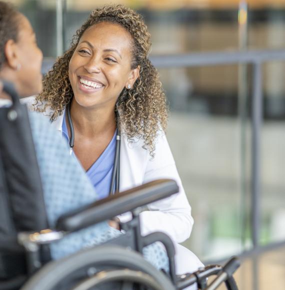 Young patient in a wheelchair with health professional