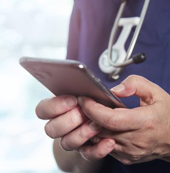 health professional holding phone