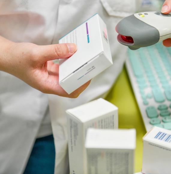 Pharmacist scanning barcode of medicine drug