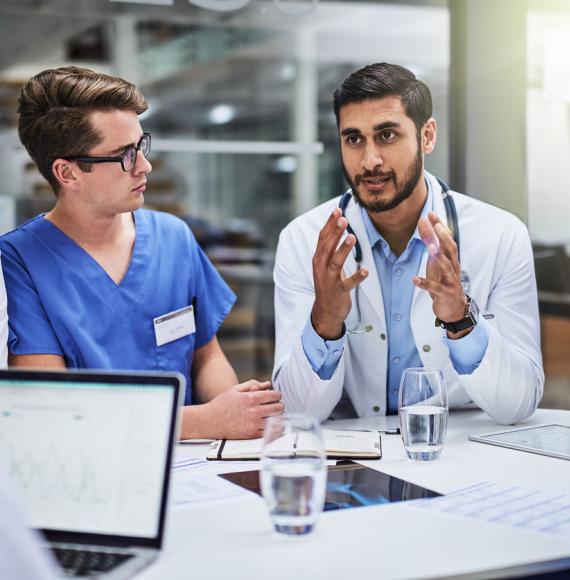 Group of health professionals talking around a table