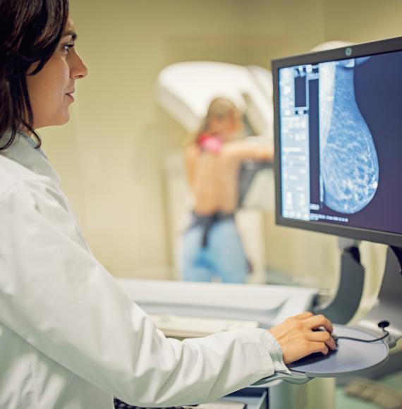Doctor working with mammography X-ray scanner in hospital