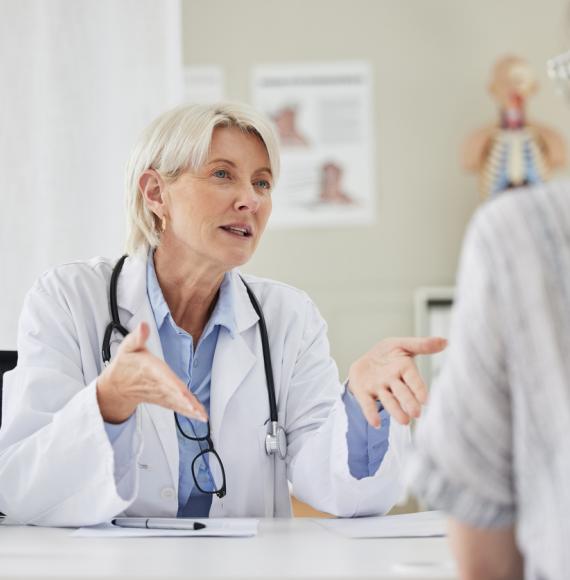 Mature doctor having a consultation with a patient