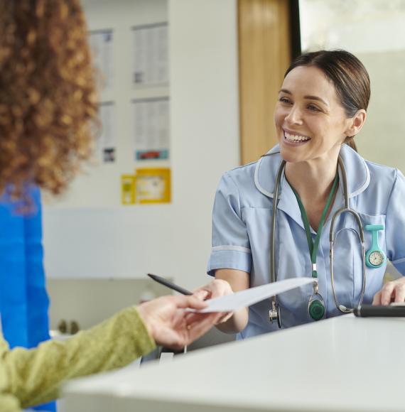 Happy nurse giving patient an advice note