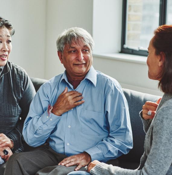 Female carer treating senior couple