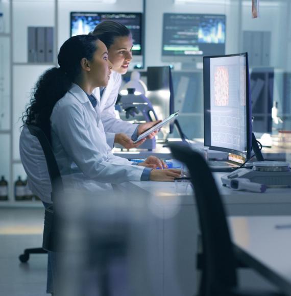 Scientists looking at a computer in a laboratory