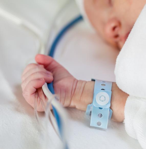 Newborn baby in hospital bed