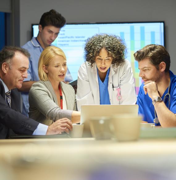 Group of health professionals talking around a table