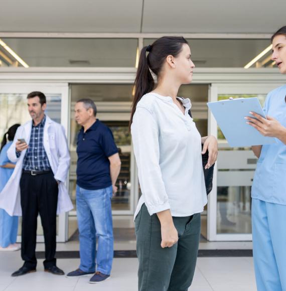 Health professionals and patients talking outside of an NHS estate following a patient discharge