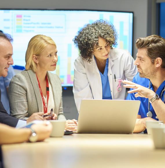 Meeting of healthcare professionals depicting the partnership between the NHS and local council to improve employment prospects