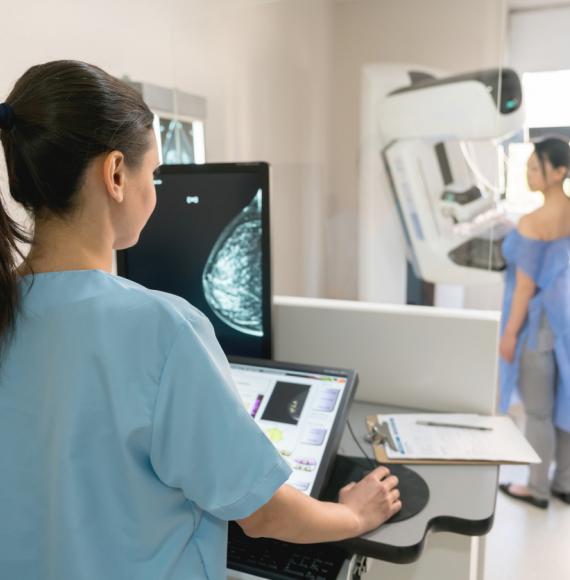 Woman undergoing a mammogram depicting cancer diagnosis