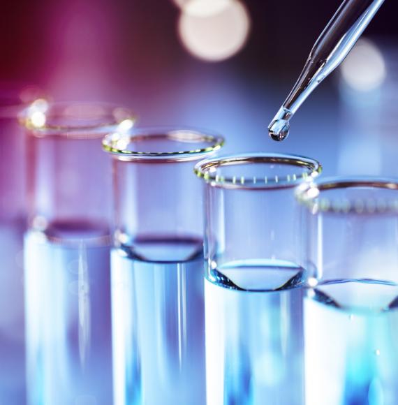 Science beakers in a line depicting cancer research