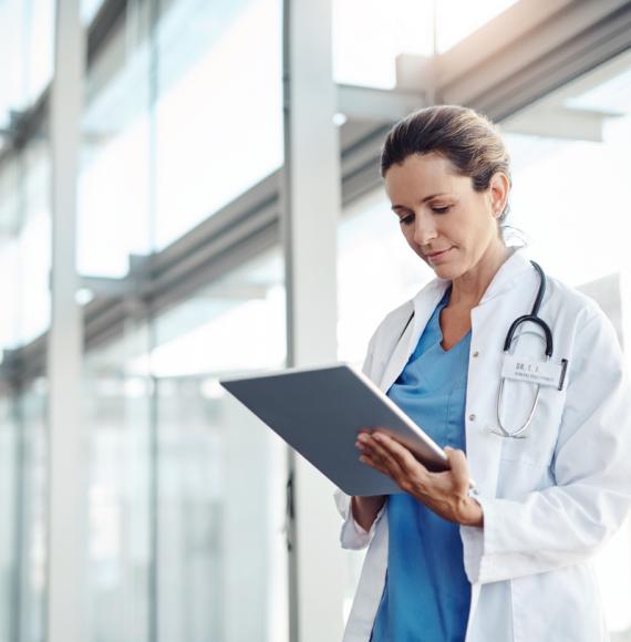 Man holding tablet depicting digital health and virtual ward technology